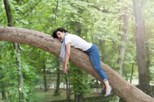 Pretty Woman Sleeping In A Tree After Being Over Worked And Having Trouble Sleeping