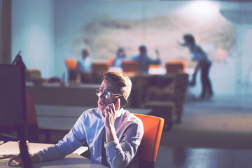 man using mobile phone in dark office