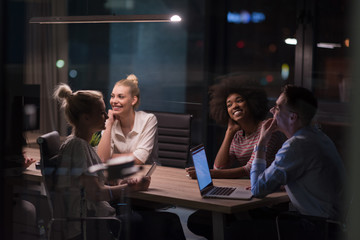 Wall Mural - Multiethnic startup business team in night office