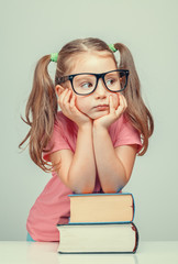 Wall Mural - beautiful cute little girl leaning on thick books