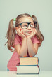 © Myst - smiling beautiful cute little girl leaning on thick books