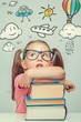 © Myst - beautiful cute little girl imagining while leaning on thick books
