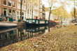 Canal and houseboat in Amsterdam. Blurred background. May 2017.