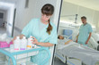 © auremar - young female nurse with cleaning product on trolley at hospital