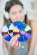 © auremar - beautiful young woman holding up discs cd dvd or blu-ray