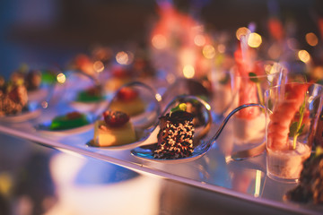 Decorated catering banquet table with different food appetizers assortment on a party