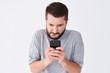 © ArtFamily - Excited bearded man in checked shirt playing on smartphone