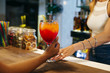 © ADDICTIVE STOCK - Hands of barman and client