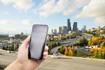 mobile phone with elevated road in modern city