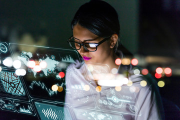 Businesswoman looking at futuristic interface screen