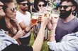 © gpointstudio - Group of friends drinking a beer at the festival