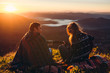 © Kirill - Young people meet the sunrise on the top of the mountain playing the guitar