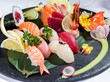 Mix of sushi and sashimi on a black dish
