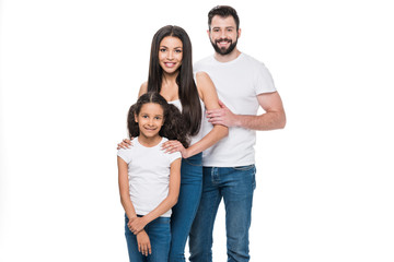 Wall Mural - young multiethnic family in casual clothing looking at camera isolated on white