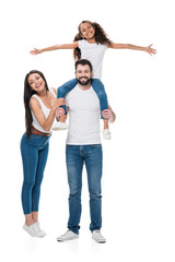 woman looking at camera while husband and daughter piggybacking isolated on white