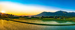 南阿蘇村_田植え後の田んぼに映える夕陽と阿蘇の風景