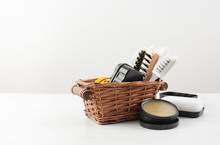 Brushes And Shoe Polish In A Basket On White