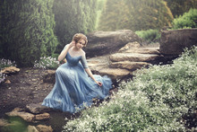 A Beautiful Young Girl Like Cinderella Is Walking In The Garden.
