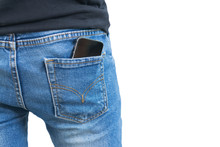 Black Smartphone In The Right Back Pocket Of Jeans Isolated On White Background With Clipping Mask.