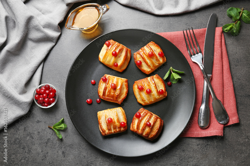 Grey plate with pastries and cranberry on served table