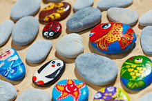 Rounded Colorful Stones Pebbles Shingle With Pictures Painted On Them
