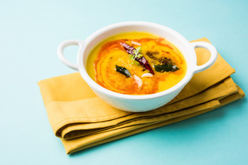 indian popular food dal fry or traditional dal tadka curry served in a bowl, isolated over white or 