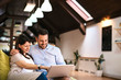 © bnenin - A young couple chilling out with a laptop in the living room.