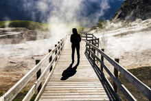 Silhouette Of Female Standing On Boardwalk With Steam In Mammoth Hot Springs In Yellowstone National Park, Wyoming