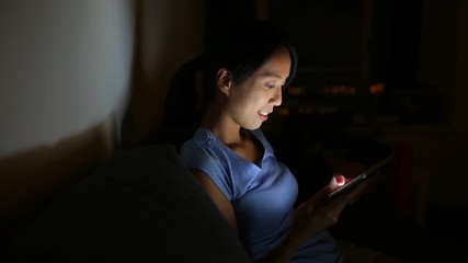 Canvas Print - Woman using tablet at night