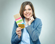 © Yuriy Shevtsov - Happy business woman holding passport, credit card and ticket.