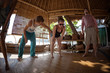 © Dudarev Mikhail - Group of young people making a breathing exercise in the bungalow