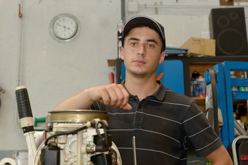 Sticker - young man mechanic repairing  motor boat