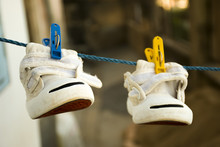 Small Old Shoes Hanging On The Wire