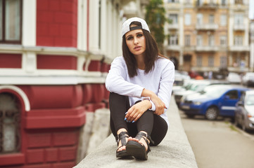 Wall Mural - Fashion model on the street. Beautiful young woman in stylish summer clothes