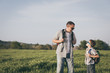 © altanaka - Father and son playing on the field at the day time.