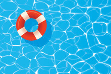 Red Pool Ring Floating In A Blue Swimming Pool. Summer Background.