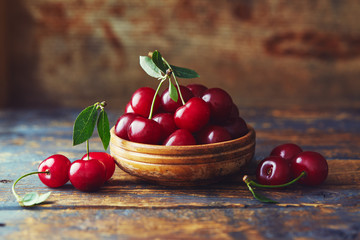 Cherries in a bowl on a wooden table