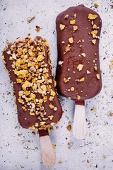Wall Mural - chocolate ice cream popsicle on rustic background
