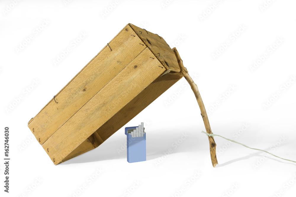 Cigarette pack under box trap Stock Photo