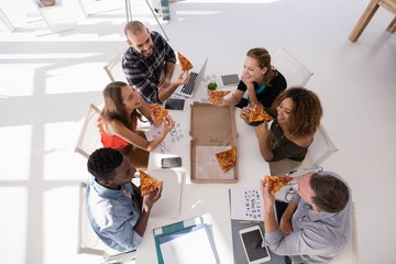 Sticker - Group of executives interacting while having pizza