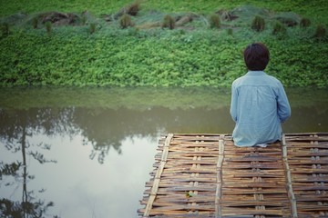 Canvas Print - Women sitting on the edge of the water is a vacation.