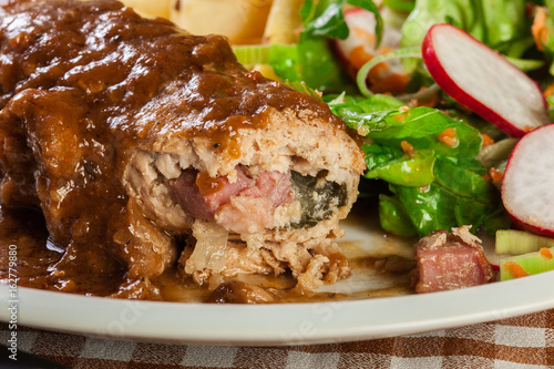 Fototapeta na szkło Pork roulade with french fries with salad