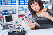© luchschenF - Female in robotics laboratory. Young woman experiment with robot