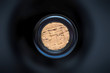 © zozzzzo - cork in the wine bottle and blurry background, photographed from above for winemaker business card or book cover