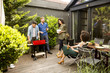 © BGStock72 - Friends grilling food and enjoying barbecue party outdoors