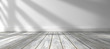 © C.Castilla - Fondo de arquitectura.Interior de casa.Habitación vacia con suelo de madera y pared blanca.Luz del sol entrando por la ventana.