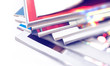 © C.Castilla - Plano cerrado de revistas y periodicos amontonados sobre fondo blanco. Información y comunicación sobre noticias