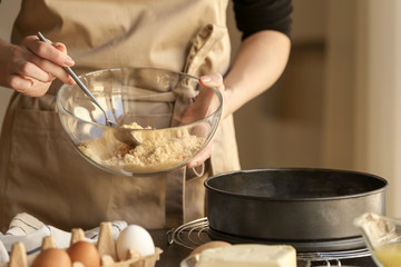 Canvas Print - Woman preparing dough for cheese cake in kitchen