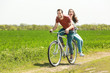 © Africa Studio - Happy young couple riding bicycle in countryside