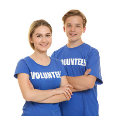 Canvas Print - Young cheerful volunteers on white background